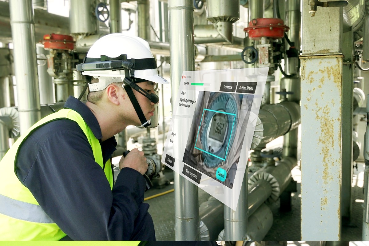 A_man_inspects_factory_equipment_wearing_industrial_smart_glasses